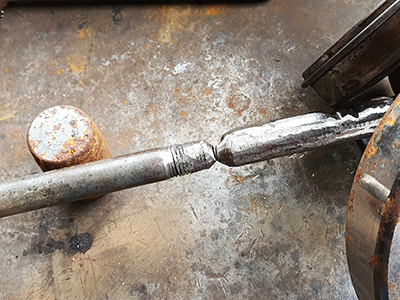 An image of recycled bolts being welded end on end into a flag pole being made by McKinley Rd Creatives
